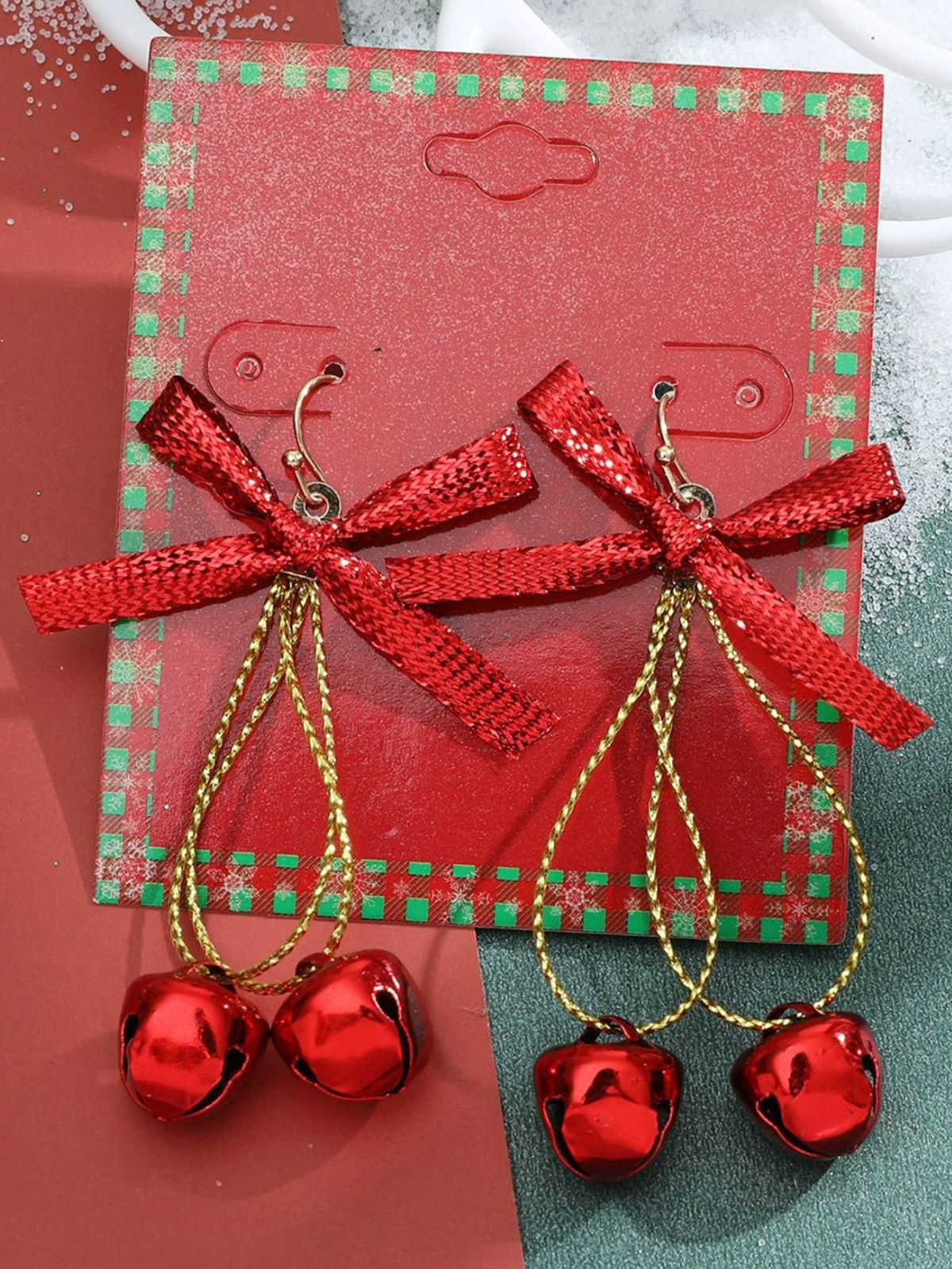 Boucles d'oreilles clochettes avec nœud scintillant de Noël